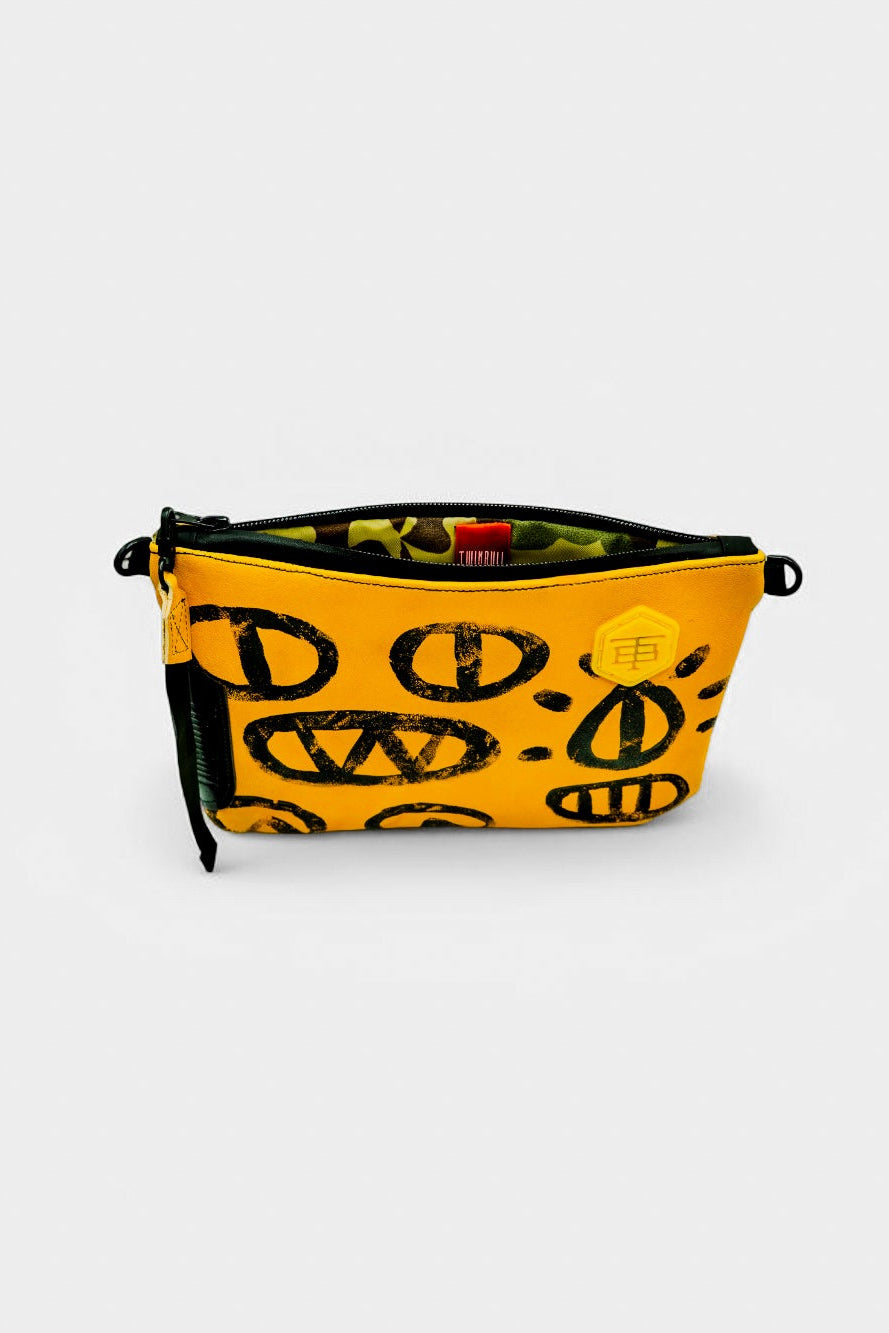TWINBULL yellow leather Pouch No. 007, featuring black hand-painted graphics and 3D printed honeycomb monogram.